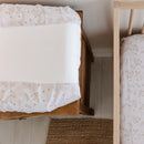 Changing Pad Cover and Crib Sheet Set – Spring (floral) in use